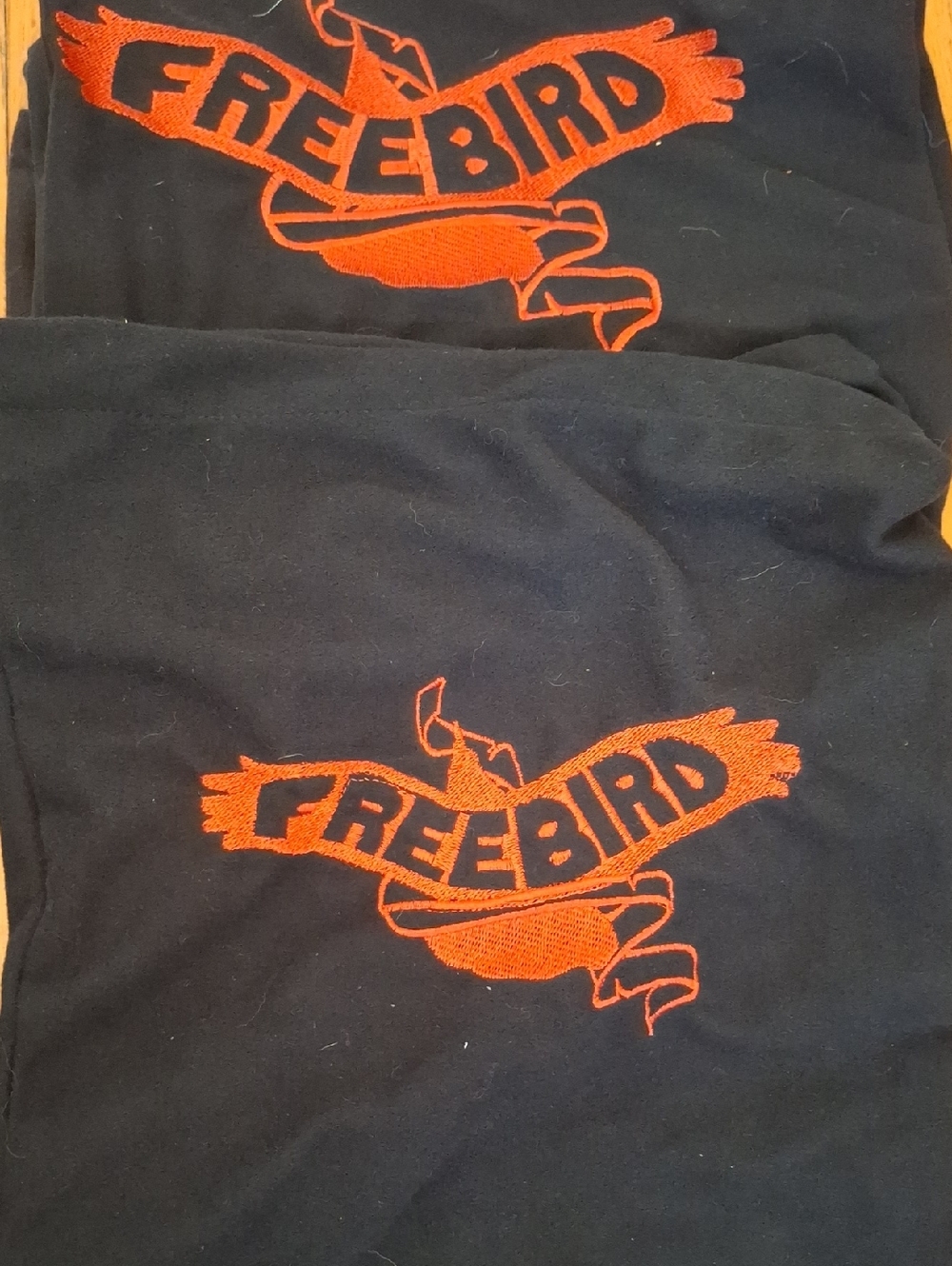 SHOE BAG COVERS Freebird by Steven Black Tee with Orange Embroidered Bird Logo.